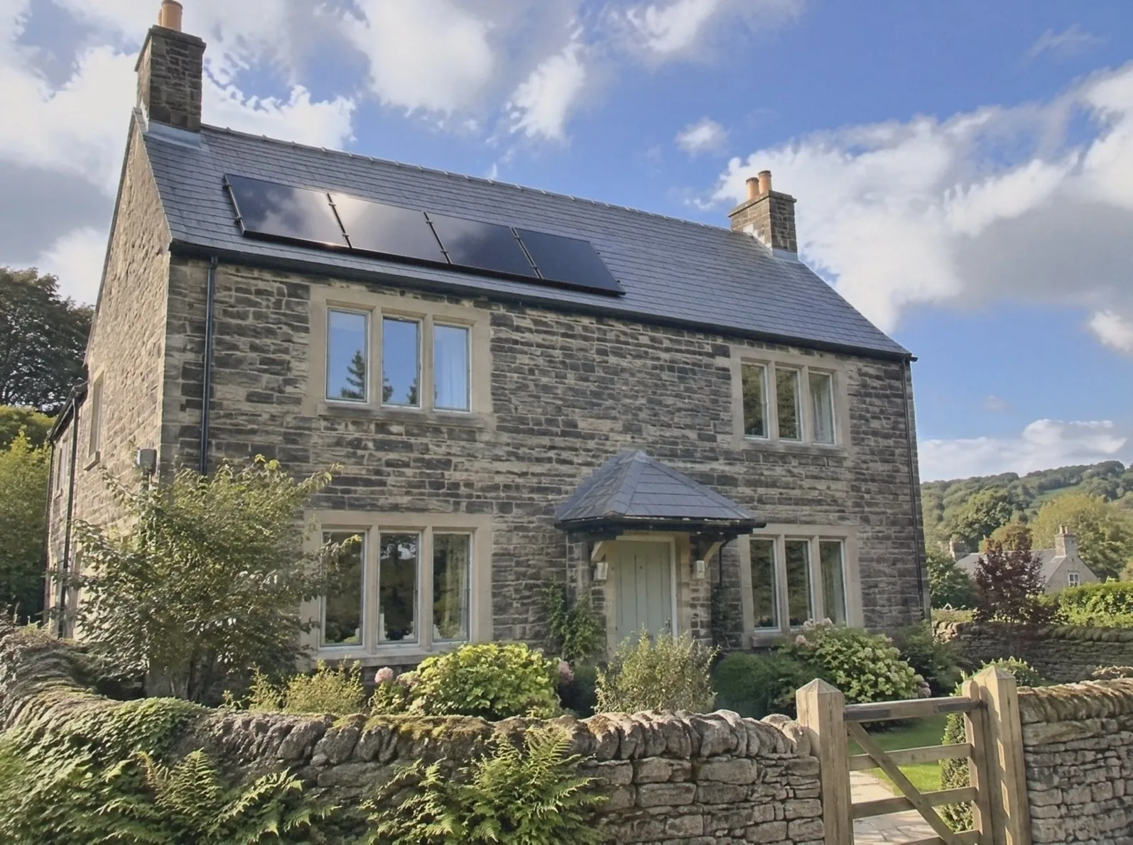 Illustration of a gritstone detached house on a sunny day, four black solar panels on its slate roof between the two chimneys, a dry-stone wall and wooden gate in front