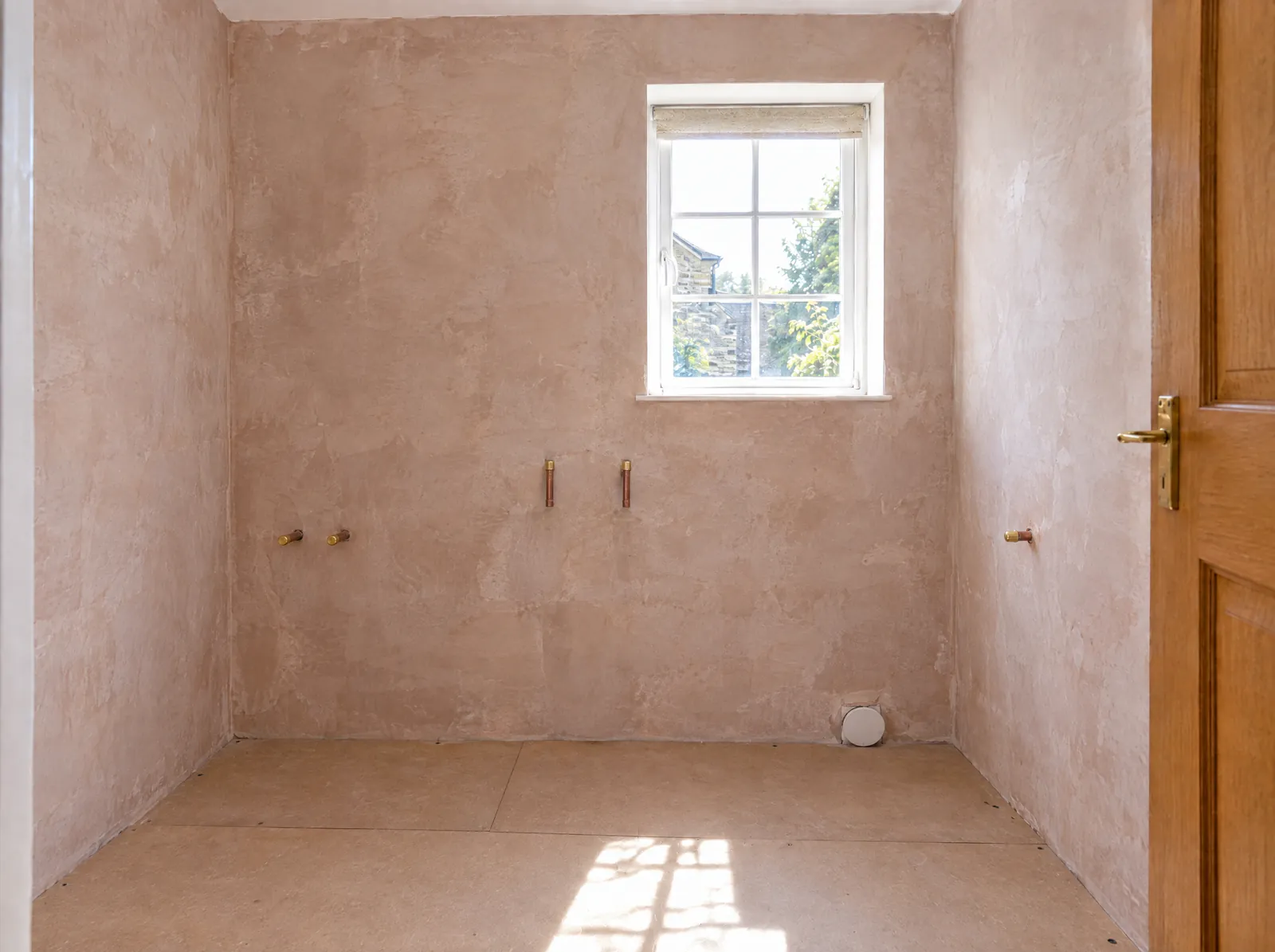 Illustration of the same bathroom stripped back to bare plaster, with the pipe ends capped and boards laid over the floor