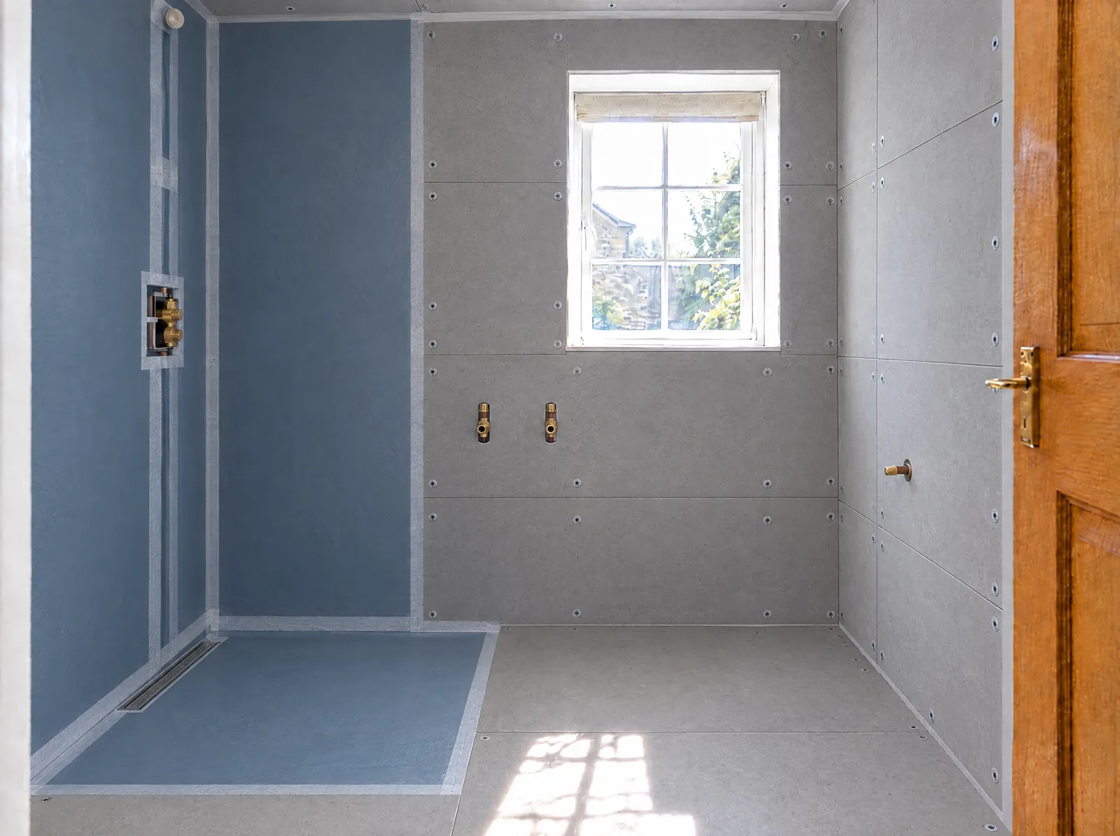 Illustration of tile backer boards fixed to every wall, with a waterproof tanking membrane over the shower area